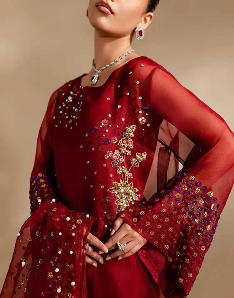 An image of a model wearing a red Pakistani dress @SearchNerve